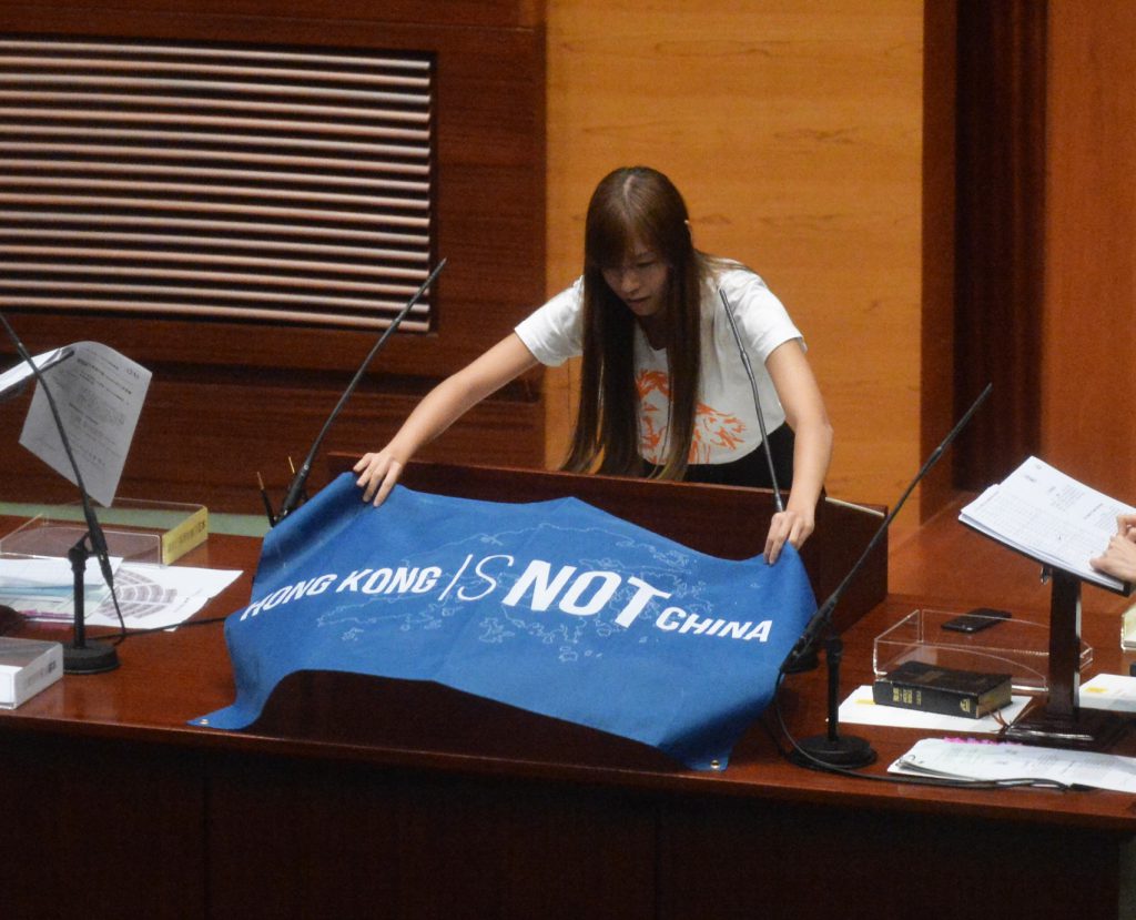 游蕙禎宣誓時展示 ‘Hong Kong is not China’的標語。 （圖片：明報）